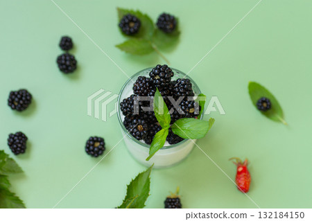 Yogurt dessert with blackberries and fresh mint 132184150