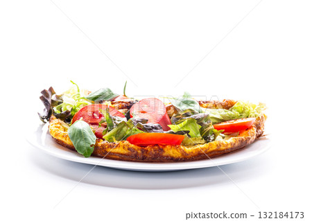 Fluffy omelette with lettuce and tomatoes on a white plate 132184173