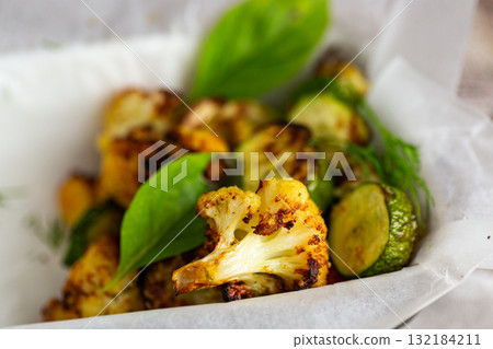 Rustic homemade roasted zucchini and cauliflower dish closeup 132184211