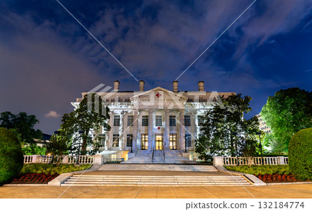 The American Red Cross National Headquarters in Washington, D.C., USA. This historic neoclassical landmark is illuminated against a dramatic night sky The American Red Cross National Headquarters in Washington, D.C., USA. This historic neoclassical landmark is illuminated against a dramatic night sky 132184774