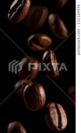 Coffee beans falling against a black background 132184936