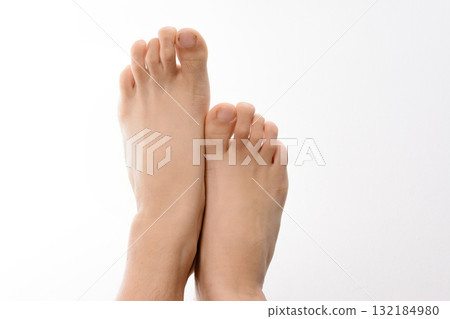 Close-up of bare feet against a white background. 132184980