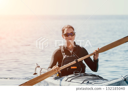 Kayaking, Water, Paddle - Woman in Sunglasses Kayaking on a Calm Water Body on a Sunny Day Kayaking, Water, Paddle - Woman in Sunglasses Kayaking on a Calm Water Body on a Sunny Day 132185040