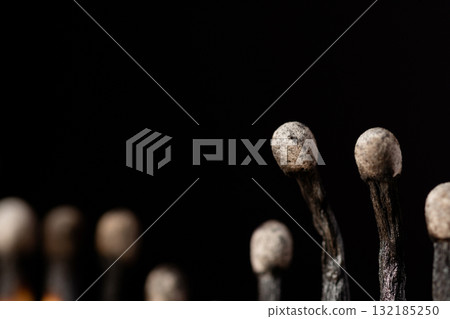 Close-up shot of burnt matches. Macro photo of black burnt match heads Close-up shot of burnt matches. Macro photo of black burnt match heads 132185250