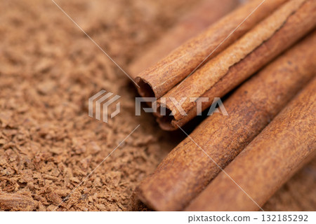 Macro shot of cinnamon powder and some sticks. Aromatic natural spices 132185292