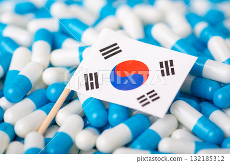 Epidemic in Korea. Flag of South Korea on piles of pills Epidemic in Korea. Flag of South Korea on piles of pills 132185312