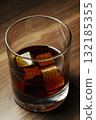 Whiskey glass with whiskey stones on wooden table 132185355