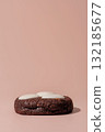 Chocolate cookie with creamy topping on soft pink background with copy space for design 132185677