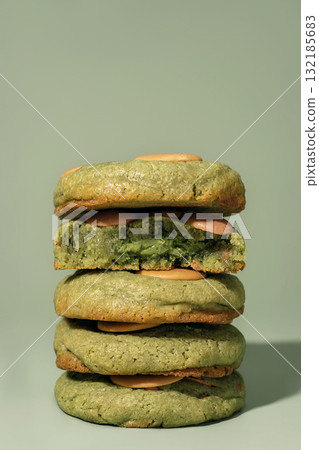 Stack of green cookies with creamy filling on a soft background featuring copy space 132185683