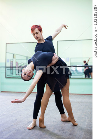 Pair of young beautiful dancers performing classical dance in studio. Learning choreography Pair of young beautiful dancers performing classical dance in studio. Learning choreography 132185887