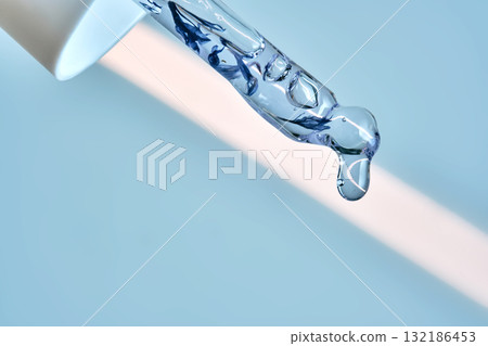 A serum pipette with lots of bubbles on a blue background. 132186453