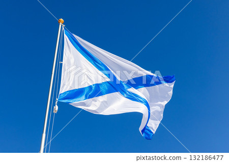 Russian Navy white flag with a blue saltire crosses a clear sky Russian Navy white flag with a blue saltire crosses a clear sky 132186477