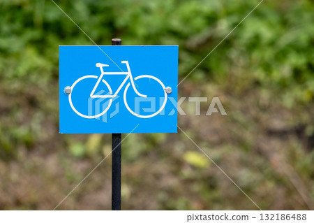 Bicycle lane. Bright blue square sign with a white bicycle icon 132186488