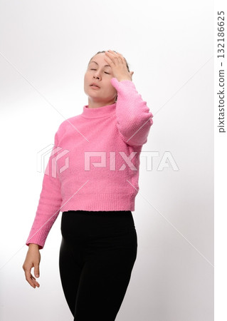 Woman experiencing discomfort, holding her head with her hand. 132186625