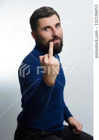 Man making rude gesture. Conveying anger or disrespect. 132186653