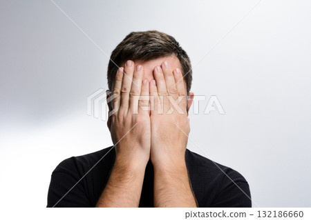 Man covering face with hands Man covering face with hands 132186660
