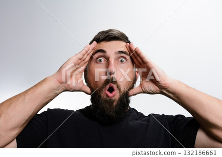 Surprised man with beard and open mouth against white background 132186661