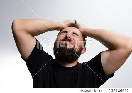 Man with beard experiencing frustration and stress. Man with beard experiencing frustration and stress. 132186662