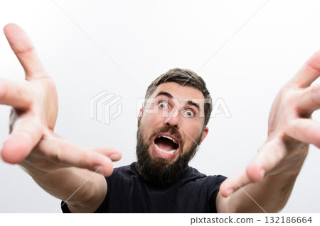Man with beard reaching forward with open hands and surprised expression. 132186664