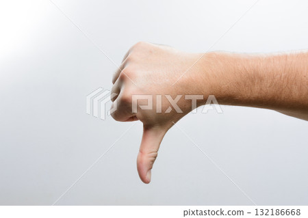 Hand giving thumbs down gesture. Hand giving thumbs down gesture. 132186668