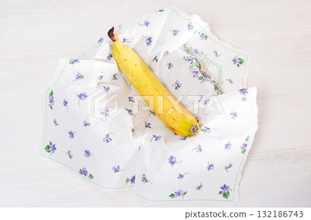Ripe banana wrapped in a decorative cloth napkin. Ripe banana wrapped in a decorative cloth napkin. 132186743