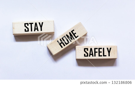 Wooden blocks with the text STAY AT HOME. BE SAFE. Wooden blocks with the text STAY AT HOME. BE SAFE. 132186806