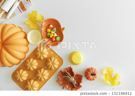 Autumn Baking Setup with Pumpkin Mold, Frosting and Seasonal Decorations Autumn Baking Setup with Pumpkin Mold, Frosting and Seasonal Decorations 132186912