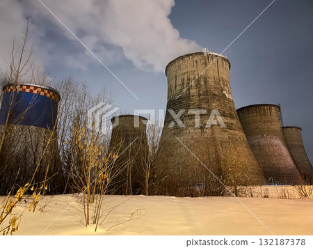 Large power plants with smoke coming out of them. Large power plants with smoke coming out of them. 132187378