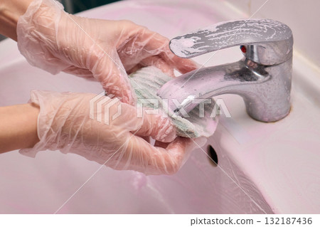 The Thorough Cleaning Process of Faucet Using Appropriate Protective Gloves for Safety The Thorough Cleaning Process of Faucet Using Appropriate Protective Gloves for Safety 132187436