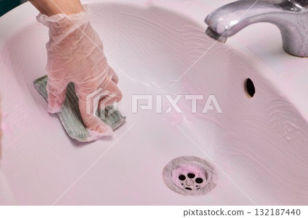 Cleaning a sink requires careful attention and effort to maintain hygiene and a fresh appearance 132187440