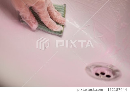 Cleaning a sink requires careful attention and effort to maintain hygiene and a fresh appearance Cleaning a sink requires careful attention and effort to maintain hygiene and a fresh appearance 132187444