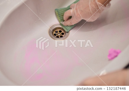 Cleaning a sink requires careful attention and effort to maintain hygiene and a fresh appearance 132187446