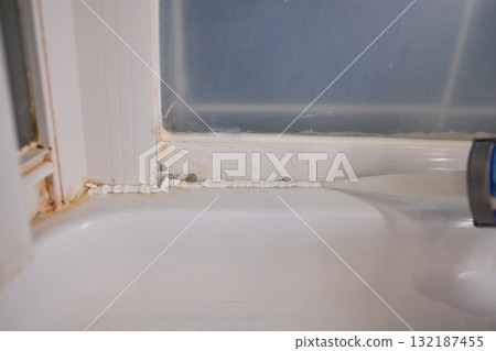 The process of applying sealant during a bathroom renovation involves multiple technical steps 132187455