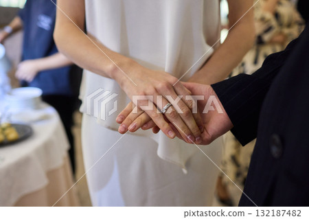 An Elegant Wedding Ceremony Featuring the Graceful Hands of Couples in Love and Joyous Unity 132187482
