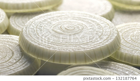 An extreme close-up of sliced onions showing detailed rings and texture, perfect for cooking website visuals, food science content, and abstract photography. 132187764