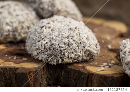 sweet marshmallows in chocolate sprinkled with coconut chips, sweet dessert marshmallows in milk chocolate with coconut 132187854