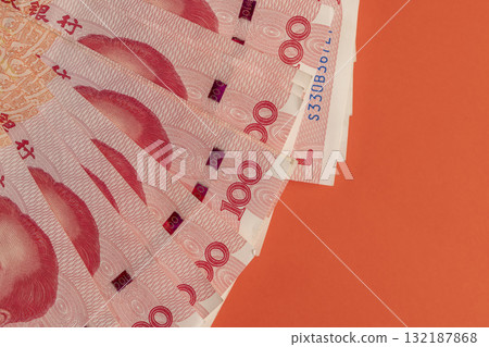 Chinese red money folded together, a large amount of money is the Chinese national currency, on a red background Chinese red money folded together, a large amount of money is the Chinese national currency, on a red background 132187868