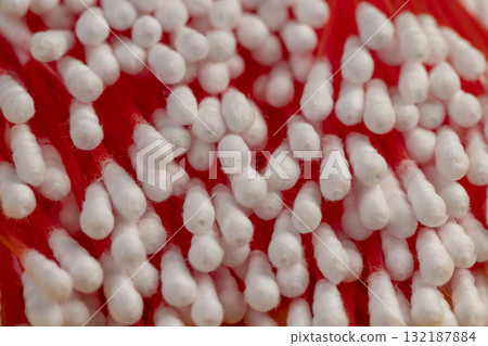 red sticks with cotton for hygienic procedures, red sticks with natural white cotton at the ends for personal hygiene 132187884