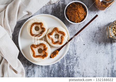 Spicy rice donuts with miso paste on a plate on the table top view 132188022