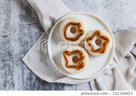 Close up of spicy rice donuts with miso paste on a plate on the table top view 132188023