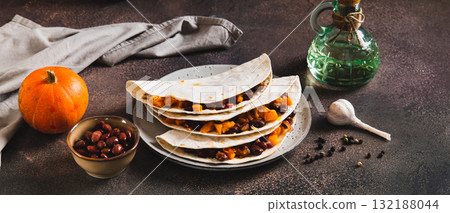 Vegetarian tacos with red beans and pumpkin on a plate on the table web banner Vegetarian tacos with red beans and pumpkin on a plate on the table web banner 132188044