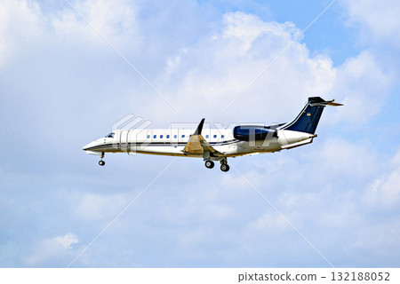Private business plane flying under blue sky with white clouds Private business plane flying under blue sky with white clouds 132188052