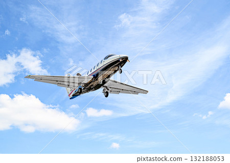 Private business plane flying under blue sky with white clouds Private business plane flying under blue sky with white clouds 132188053
