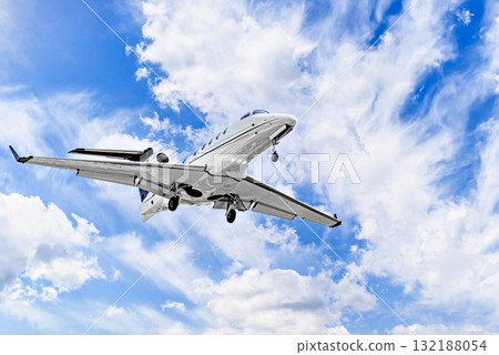 Private business plane flying under blue sky with white clouds Private business plane flying under blue sky with white clouds 132188054