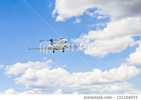 Private business plane flying under blue sky with white clouds Private business plane flying under blue sky with white clouds 132188055