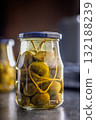Pickled capers berries in jar on black table. 132188239