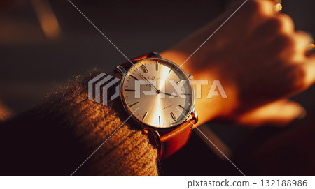 A close-up shot of a person's wrist adorned with a luxury wristwatch. A luxurious feel.  This is AI-generated item 132188986