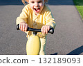 Child scooter riding. Girl yellow scooter park. Motion day lifestyle travel. 132189093