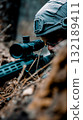 A man wearing a hat and glasses looking through a rifle scope 132189411