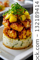 A white plate topped with rice covered in pineapple and sauce 132189414